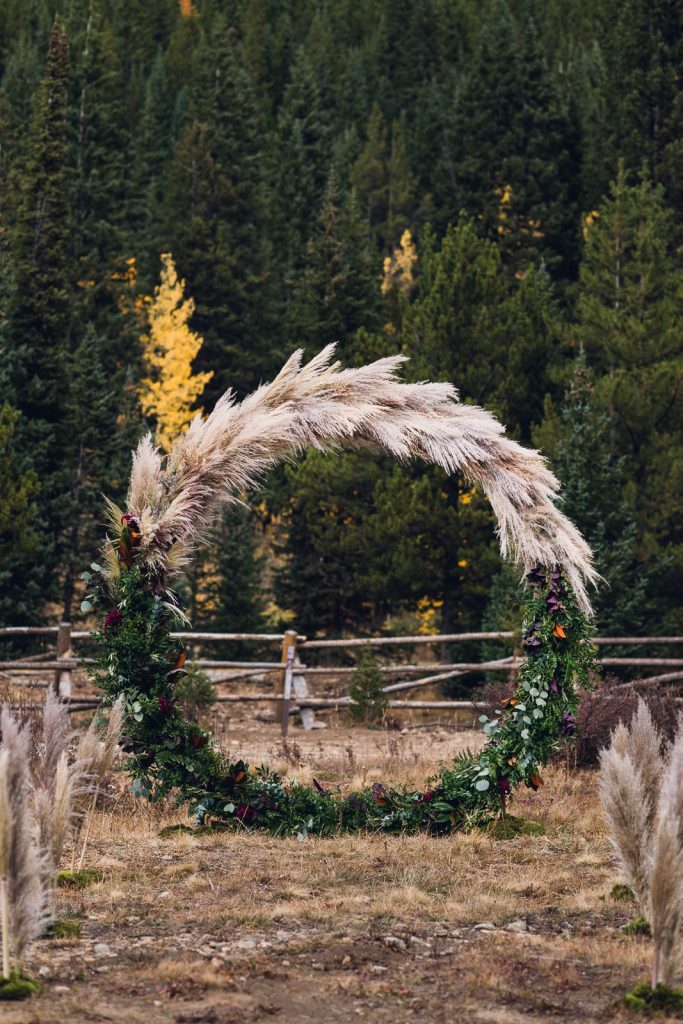 full circle wedding arch with greenery and pampas grass