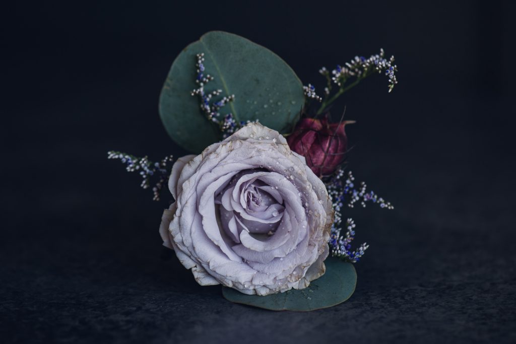 light purple flower and eucalyptus boutonniere