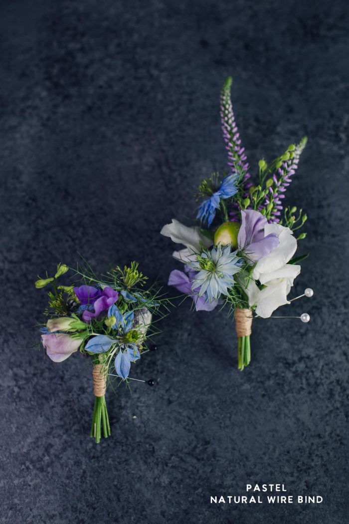 matching set of pastel blue and purple boutonnière and corsage