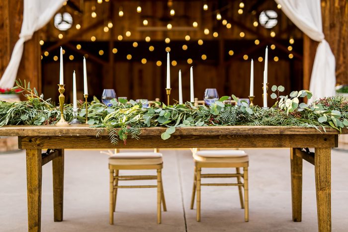 wedding table set with greenery garland