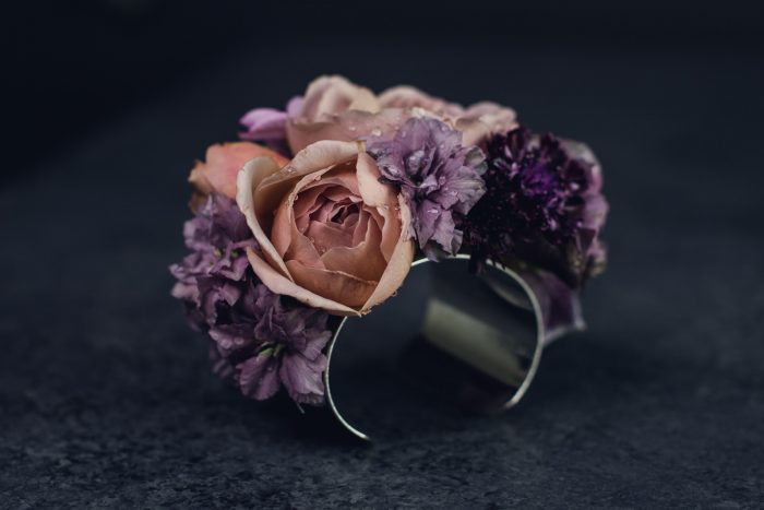 peach and purple corsage on silver wrist cuff