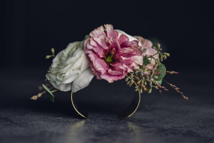 pink and white wrist corsage on gold cuff