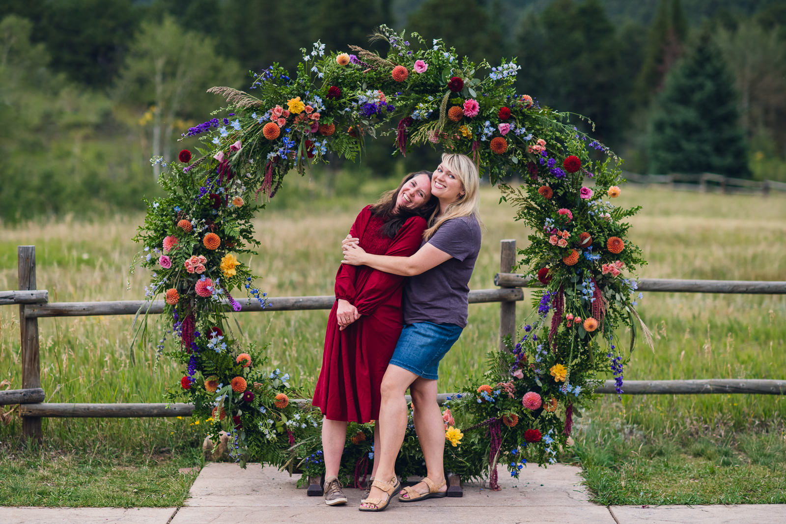 wedding florists in front of a colorful circle arch for mountain wedding ceremony