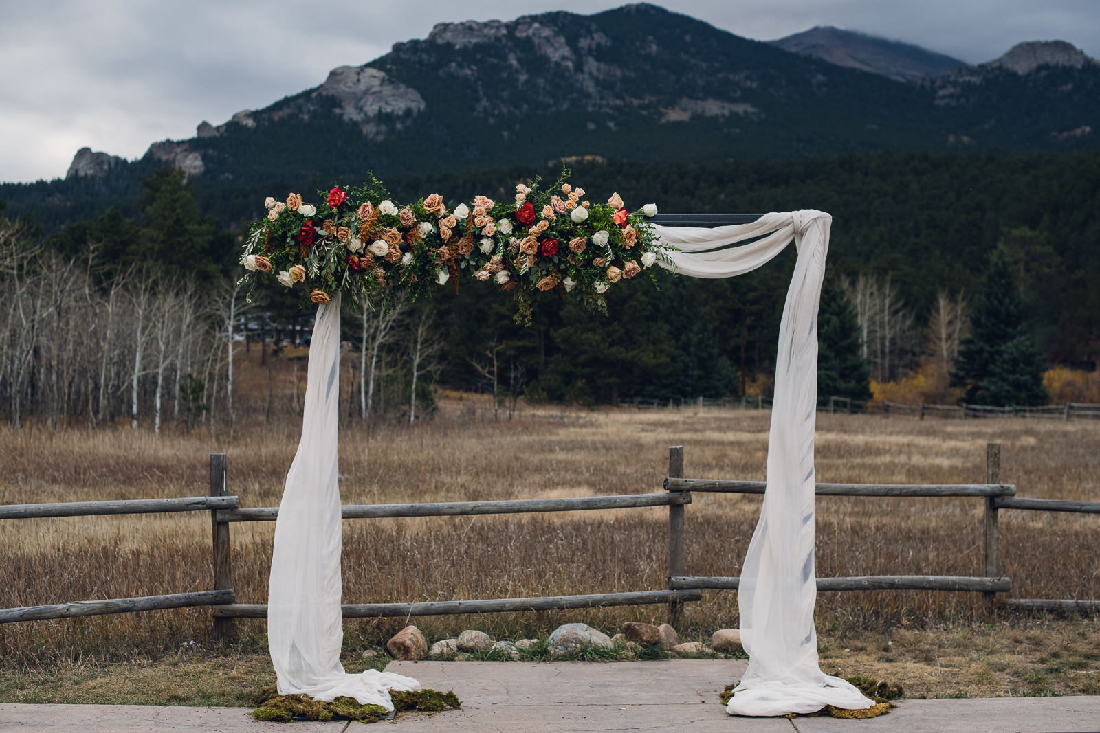rectangle wedding arch with flowers and silk in the mountains
