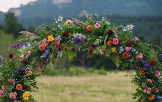 colorful circle floral arch for mountain wedding ceremony