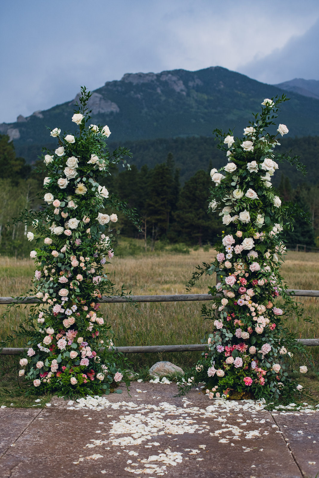 freestanding flower pillars for wedding ceremony arch in front of mountains in estes park colorado