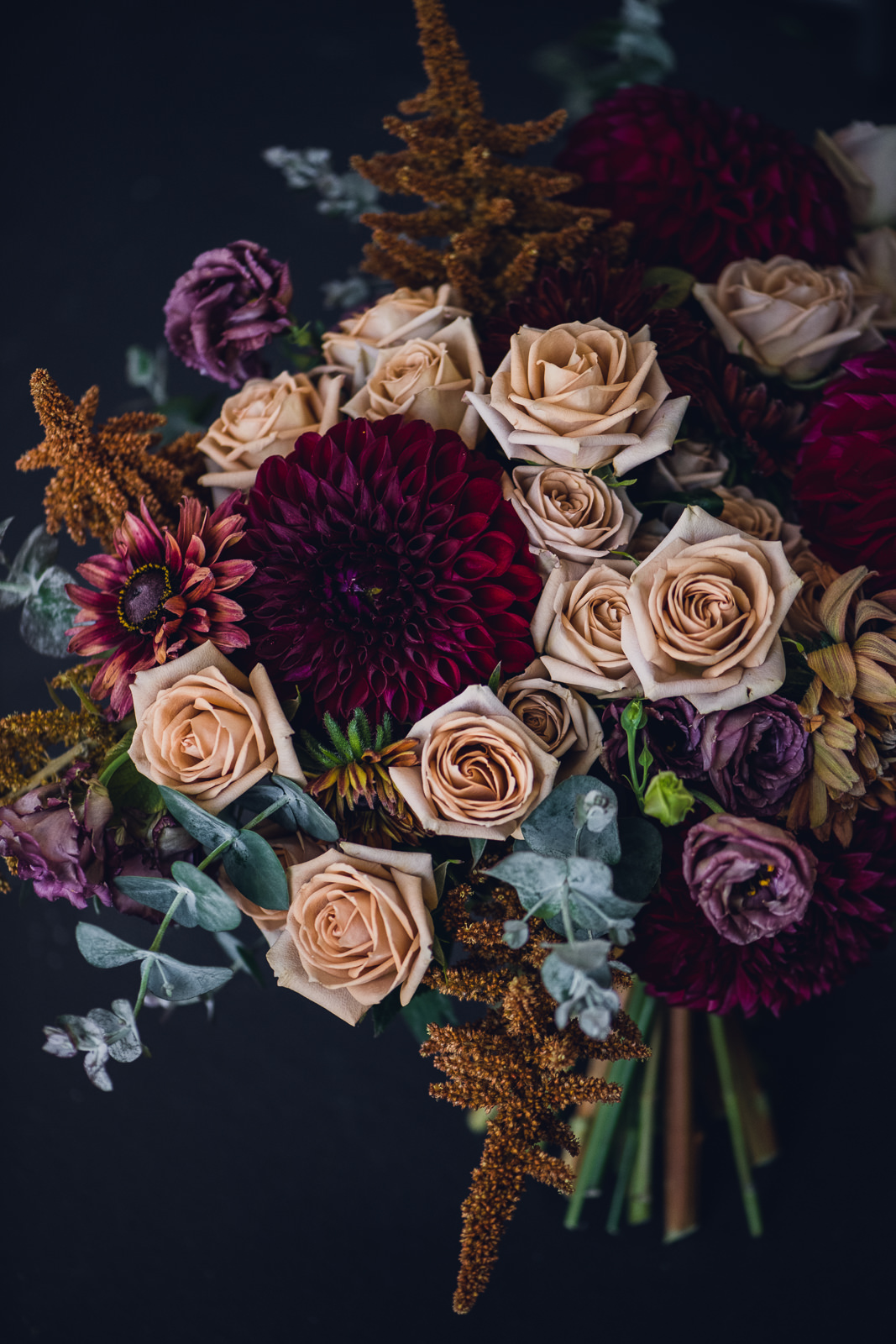 refined moody autumn floral color palette with roses and dahlias in a bridal bouquet