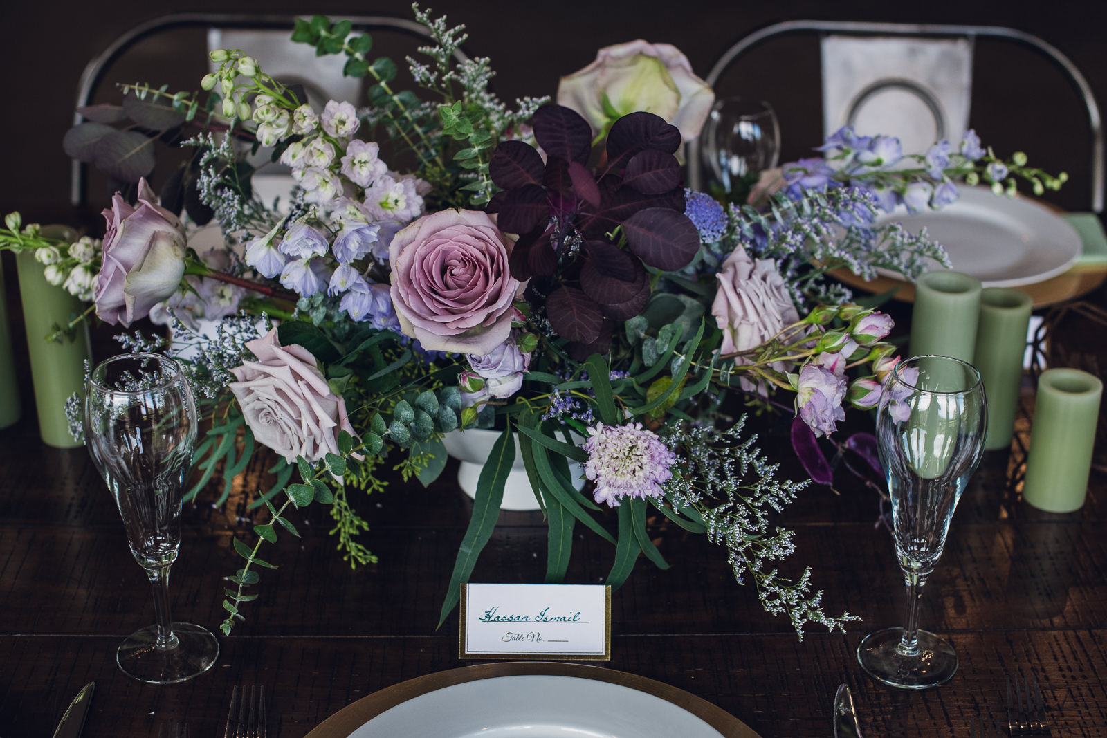 shades of purple flowers in a large table centerpiece for colorado wedding reception