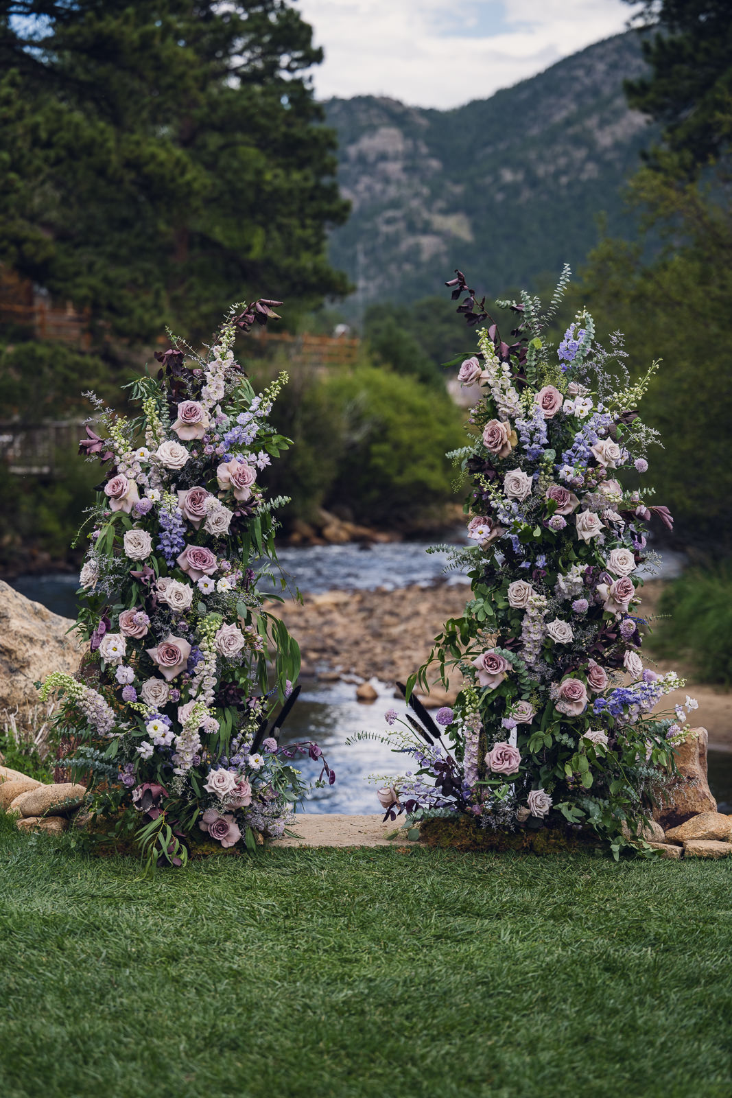 free standing floral pillars for wedding ceremony covered in shades of purple flowers